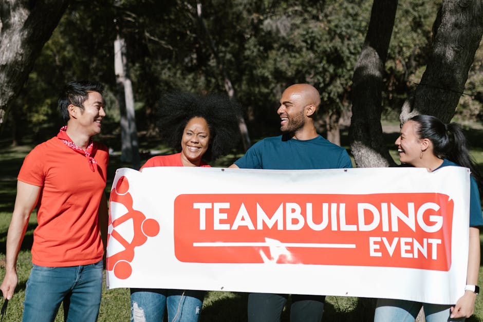 A joyful group of diverse adults at a teambuilding event in a park.